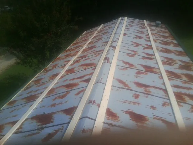 Rusted metal roof panels with new wood purlins before replacement — Storm Damage Roof Repair in Elko New Market by Roofing Brothers